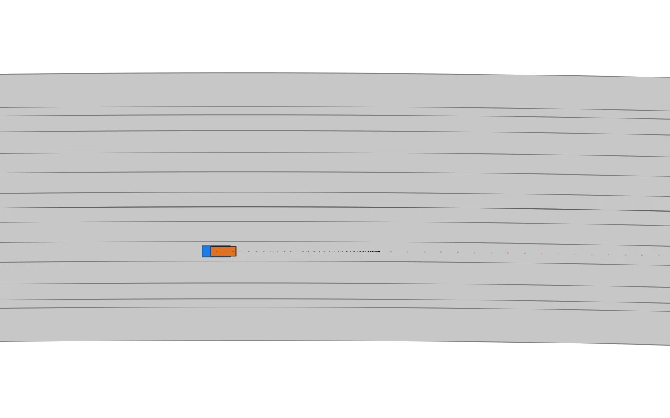 The same file rendered by commonroad-io's official renderer: grey lanelets, the orange ego overlapping the blue obstacle, a dotted future trajectory ahead of them